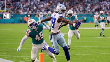 MIAMI GARDENS, FLORIDA - DECEMBER 24: CeeDee Lamb #88 of the Dallas Cowboys scores a touchdown while defended by Duke Riley #45 of the Miami Dolphins during the first quarter at Hard Rock Stadium on December 24, 2023 in Miami Gardens, Florida.   Stacy Revere/Getty Images/AFP (Photo by Stacy Revere / GETTY IMAGES NORTH AMERICA / Getty Images via AFP)